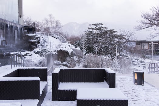 Snow covered chairs in garden photo