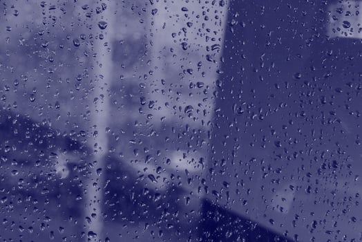 blue glass covered with rain drops photo