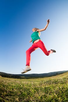 Woman jumping outdoors photo
