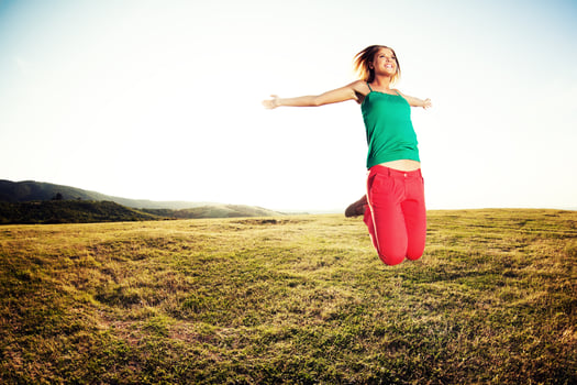 Woman jumping outdoors photo