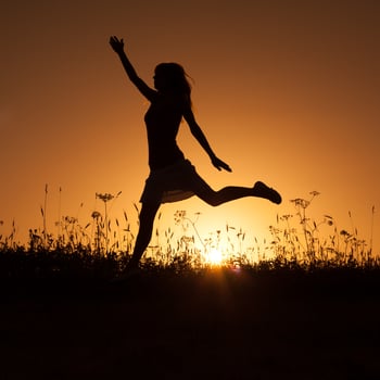 Silhouette of a woman at sunset photo
