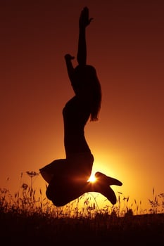 Silhouette of a woman at sunset photo
