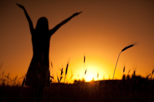 Silhouette of a woman at sunset photo