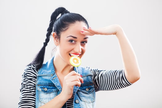 A woman eating a lollipop photo