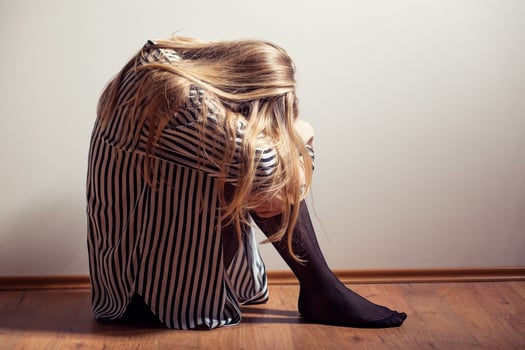Depressed woman with her head down photo