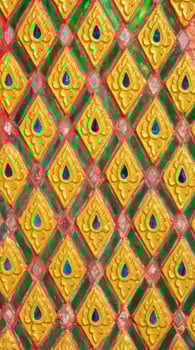 Pattern of gold flower carved on stucco design of native wall, Thai style in temple photo