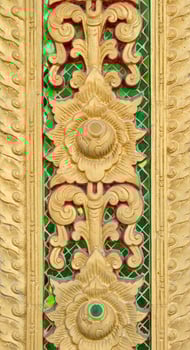 Pattern of gold flower carved on stucco design of native wall, Thai style in temple photo