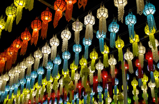 colorful hanging lanterns lighting on night sky in loy krathong festival at northern of thailand photo