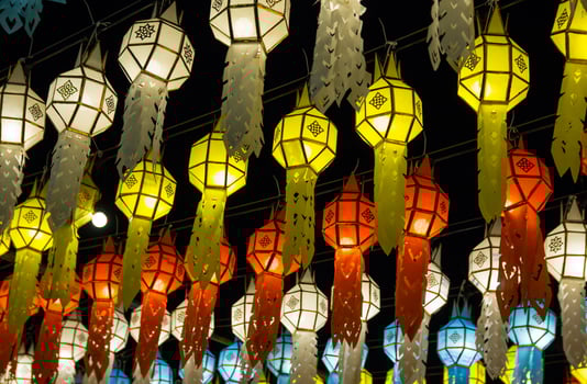 colorful hanging lanterns lighting on night sky in loy krathong festival at northern of thailand photo
