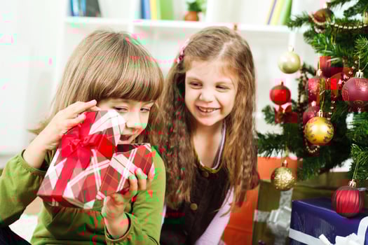 Young girs opening Christmas presents photo