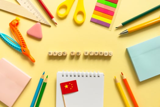 Back to school background. School accessories on a yellow background. Wooden blocks with letters photo