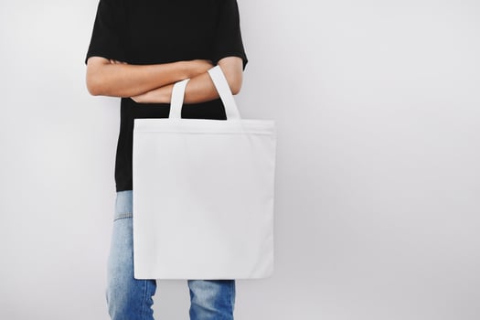 hipter woman holding eco fabric bag isolate on white background photo