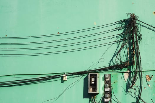 old electric wire on green wall photo