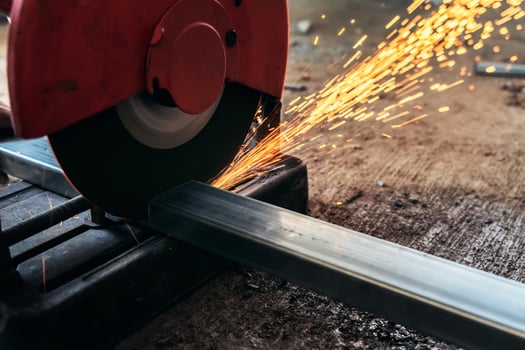 Circular saw cutting steel in construction site photo