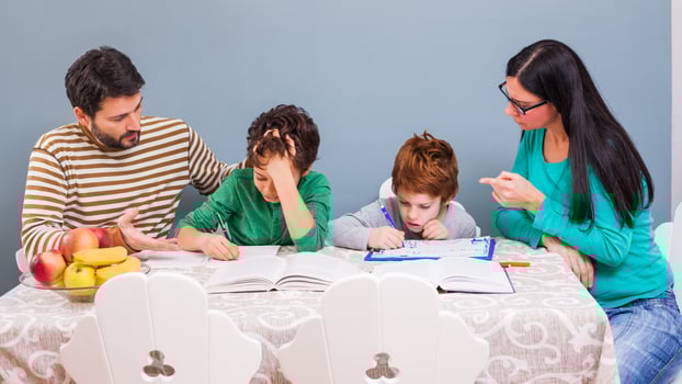 Parents helping their children with their homework photo