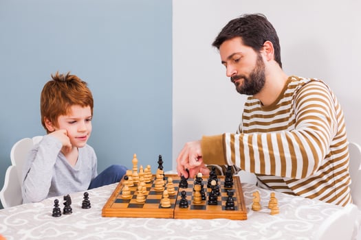 A man playing chess with a child photo