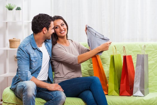Portrait of a young couple exchanging gifts photo