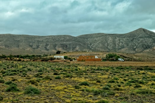 empty mysterious mountainous landscape from the center of the Canary Island Spanish Fuerteventura with a cloudy sky photo
