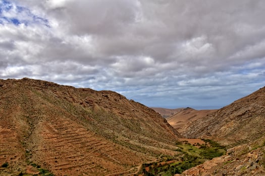 empty mysterious mountainous landscape from the center of the Canary Island Spanish Fuerteventura with a cloudy sky photo