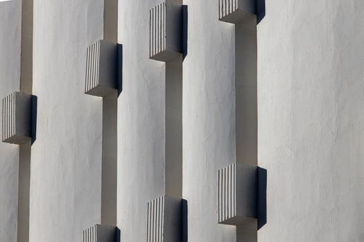 interesting original elements of the balconies in the white building photo