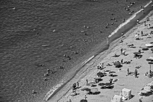 a picturesque beach view with a bird's eye view full of people resting in vacation photo