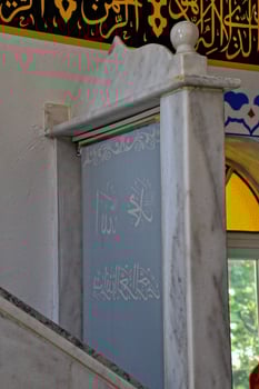 modest simple interior of a small Turkish village mosque with one miner photo