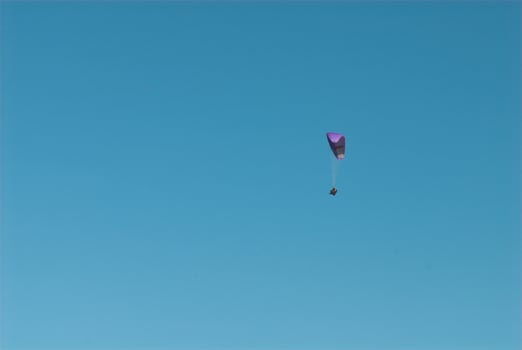 paragliders in the blue cloudless sky photo
