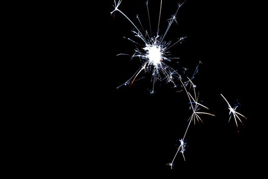 cold silver sparkles on a black background close-up photo