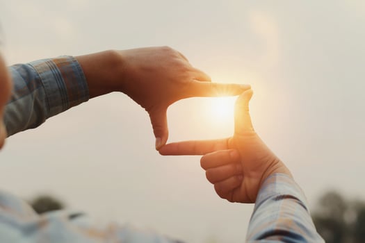 close up woman make hand framing gesture distant view. business concept photo