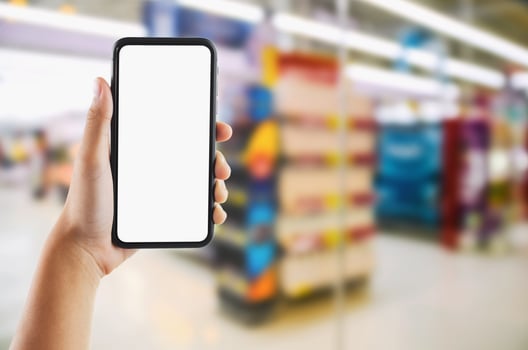 hand holding mobile white screen on  Supermarket store blur background photo