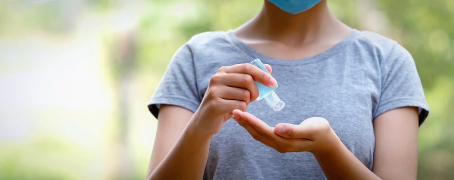 woman using alcohol gel from bottle and applying sanitizer for hand make cleaning virus covid 19 photo