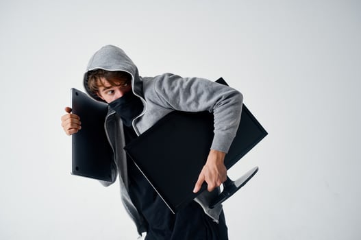 male thief stealth technique robbery safety hooligan light background photo