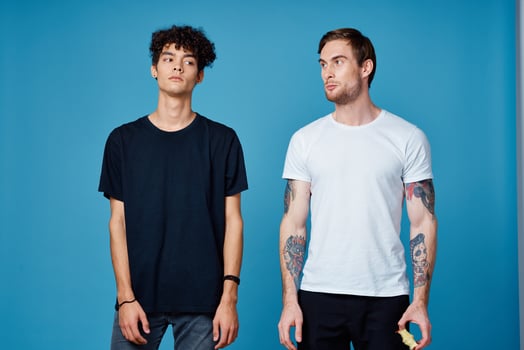 two men in t-shirts on a blue background and pants chatting friends photo
