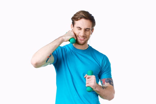 man with dumbbells in his hands blue t-shirt exercise fitness headphones photo