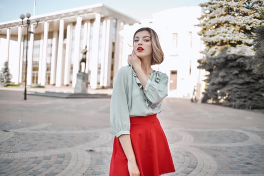 cute blonde girl in red skirt outdoors posing walk photo