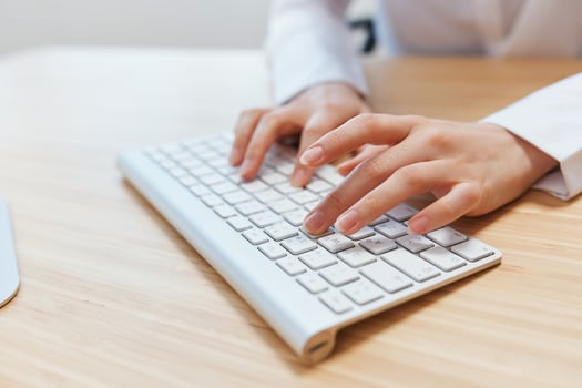 Closeup shot hands of businesswoman journalist office worker freelancer typing report doing documents on keyboard. Online communication, Remote job or Education. Copy space, wide angle photo