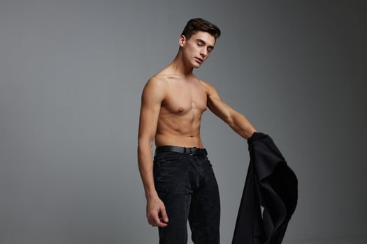 Handsome man nude torso black jacket posing self confidence lifestyle charm photo