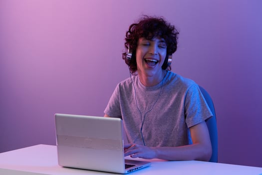 gamer cyberspace playing with headphones in front of a laptop Lifestyle technology photo