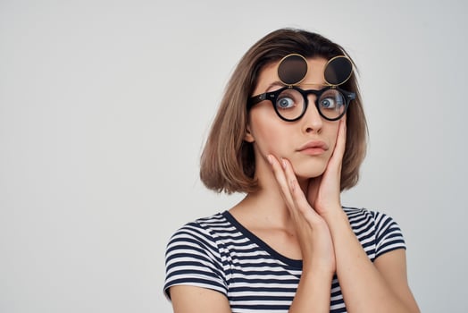 woman in striped t-shirt fashion glasses studio posing photo