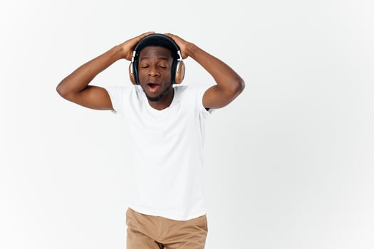 man with headphones listening to music with eyes closed enjoyment photo