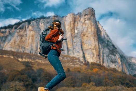cheerful woman hiker nature landscape rocky mountains travel photo