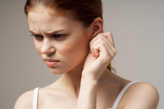 sick woman ear pain health problem dissatisfaction light background photo