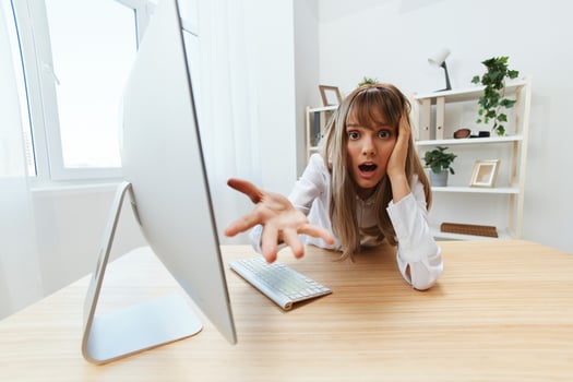 Shocked upset adorable blonde businesswoman worker made a critical mistake opening mouth think of problem solution recline on hand spread hand at camera in light office. Copy space, wide angle photo