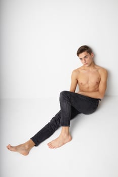 Man sitting on the floor naked torso modern style self-confidence photo