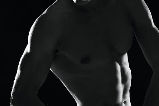 sporty muscular man in black shorts bodybuilder dark background photo