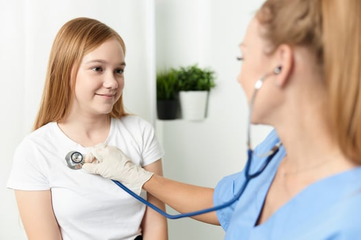 doctor with stethoscope next to the child patient hospital photo