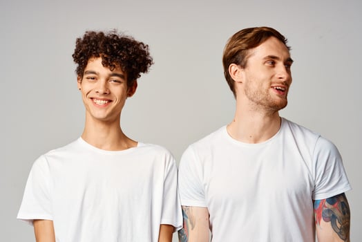 Two cheerful friends in t-shirts stand side by side isolated background joy photo