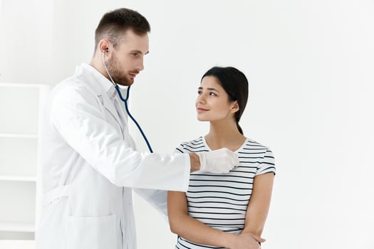 doctor in a white coat stethoscope examination of a patient hospital photo