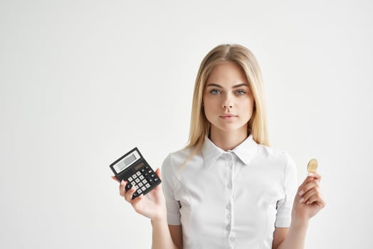 Businesswoman calculator in hand and bitcoin light background photo