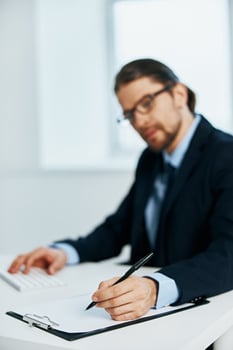 male manager with glasses work desk documents work photo